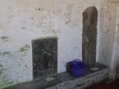Tintagel: stone bench, Roman pillar and C14 brass